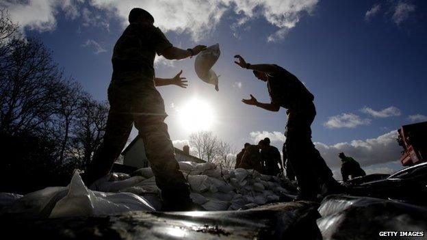 Marines from 40 Commando help build a sandbag wall around a property in Moorland