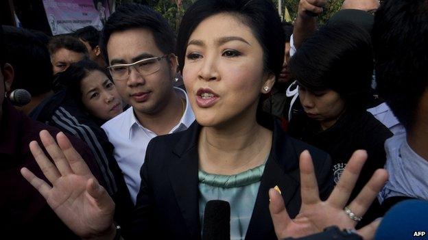 Thai Prime Minister Yingluck Shinawatra answers questions from the press after voting at a polling station in Bangkok on 2 February 2014