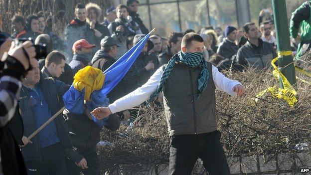 Bosnian protestors try to storm a local government building in the Bosnian capital Sarajevo, on February 7, 2014.