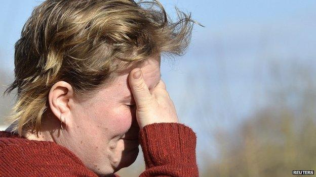 Farmer Hayley Matthew reacts as she leaves her property in the village of Moorland