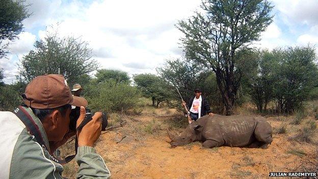 Vietnamese hunter with dead rhino