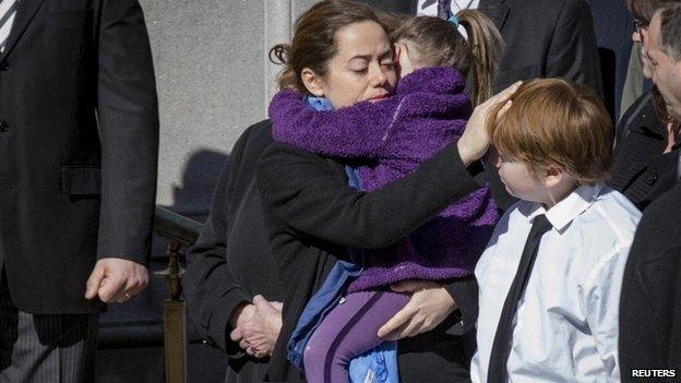 Mimi O'Donnell, former partner of actor Phillip Seymour Hoffman, holds her daughter Willa as she touches the head of their son Cooper as the casket arrives for the funeral of actor Hoffman in the Manhattan borough of New York, 7 February 2014