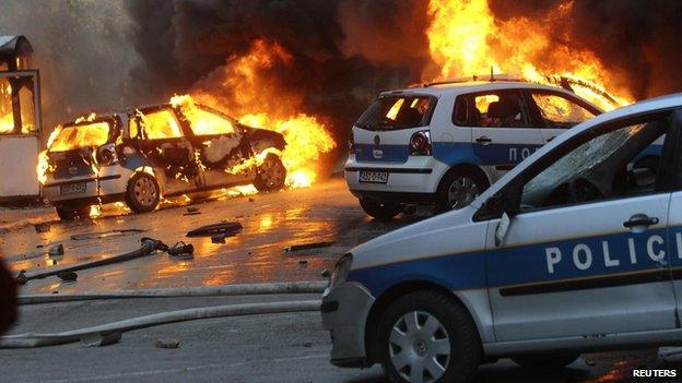 Cars burn as anti-government protesters clash with police in Sarajevo February 7, 2014.