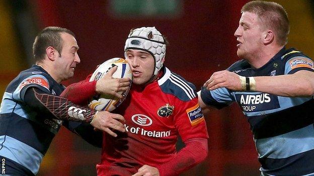 Munster's Duncan Williams is closed down by Gareth Davies and Macauley Cook of Cardiff