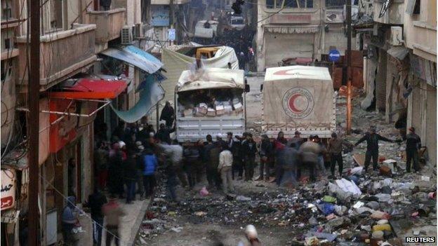 Red Crescent trucks deliver aid in Homs
