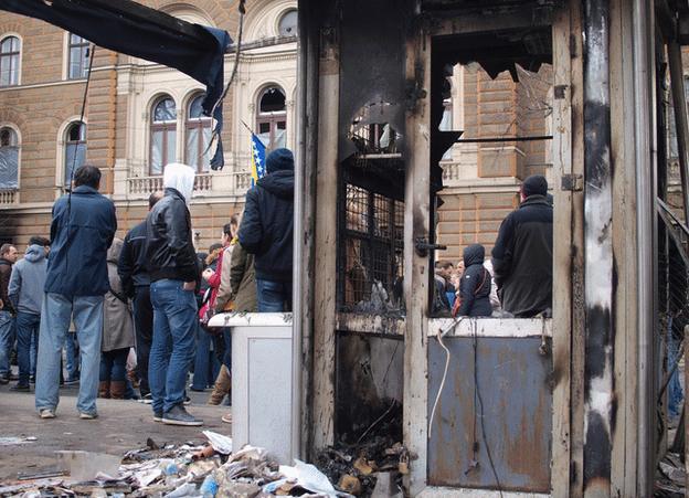 People stand around the damaged presidency building in Sarajevo, 9 February