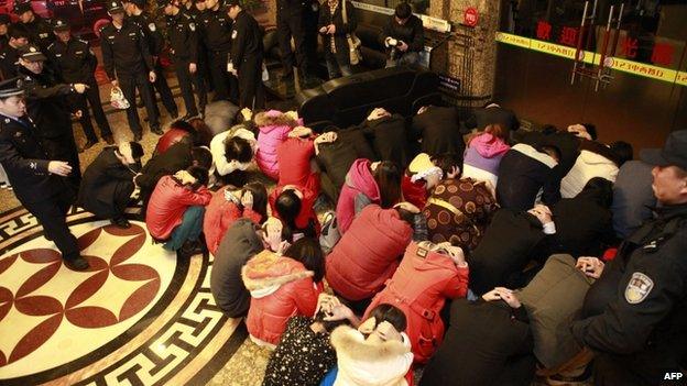 Chinese police round up alleged sex workers and clients at an entertainment centre in Dongguan, southern China's Guangdong province, 9 February 2014