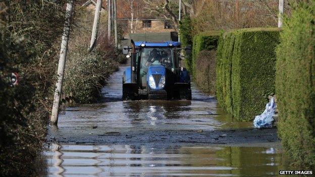 A tractor drives in flood water at Burrowbridge on the Somerset Levels on 9 February 2014.