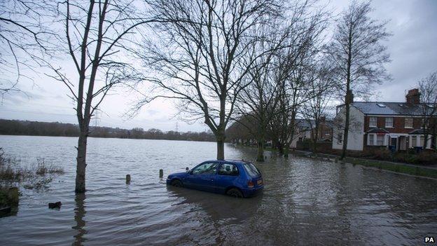 A car sits in flood water near Osney Industrial Estate in Oxford