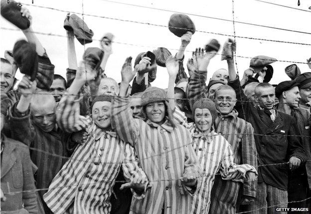 Young prisoners interned at Dachau concentration camp cheering their liberators