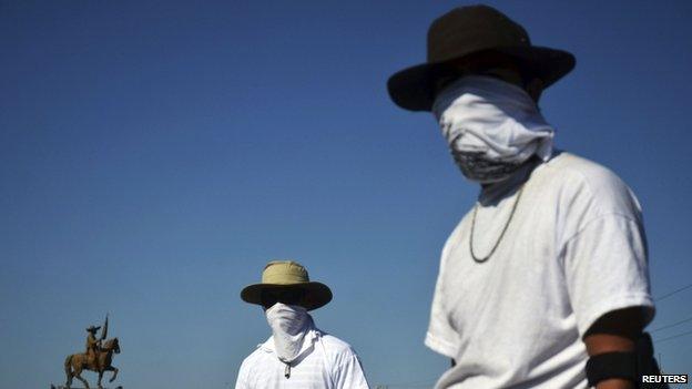 Vigilantes stand at a checkpoint in Mugica near Apatzingan on 14 January, 2014