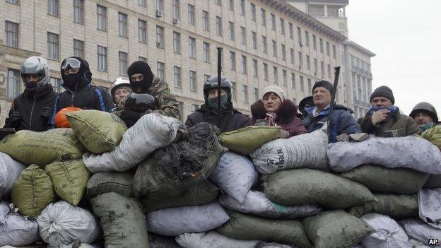 Protesters guard the barricade in front of riot police in Kiev, Ukraine, on 28 January 2014.