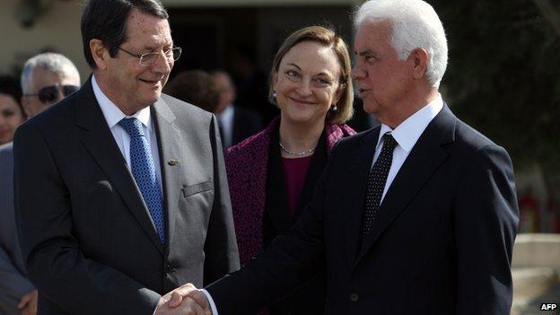 Cypriot President Nicos Anastasiades shaking hands with Turkish Cypriot leader Dervis Eroglu