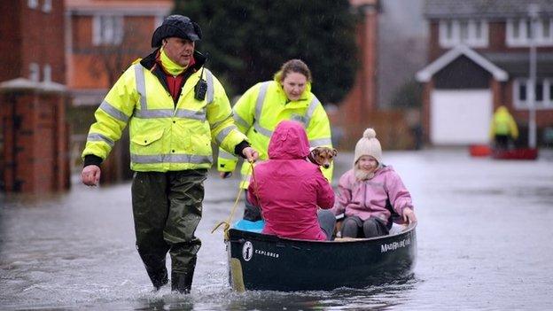 Volunteers help residents brave flood water in Purley on Thames.