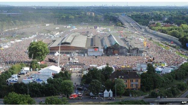 Aerial view of the vast crowd at the festival site, a former freight area, in Duisburg, western Germany.