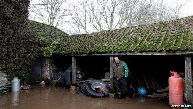 Farmer James Winslade looks at flood damage at his flooded farm in Moorland on January 28, 2014 in Somerset, England. The third-generation farmer, whose family has been farming the area for 150 years, calculates 94 percent of his farmland is under water