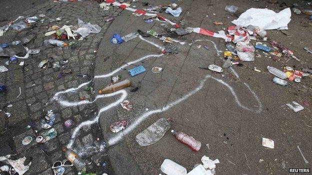 The position of a victim of a deadly stampede is marked on the street between two tunnels in Duisburg in this 25 July 2010 file photo