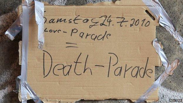 Days after the tragedy, a placard attached to the tunnel wall reads "Saturday 24 July 2010 Love-Parade = Death-Parade"