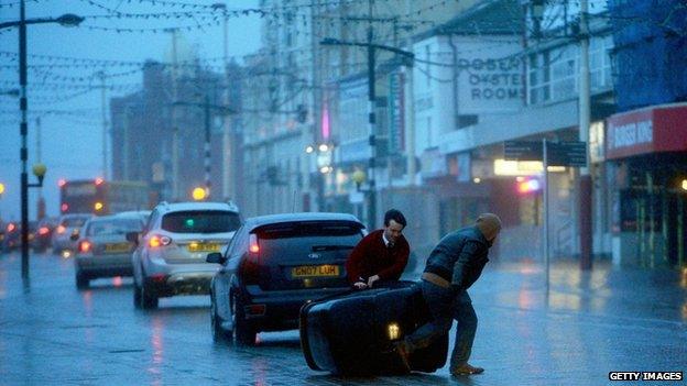 People struggle in the high winds at Blackpool promenade