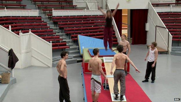 A team of circus acrobats practicing their jumps