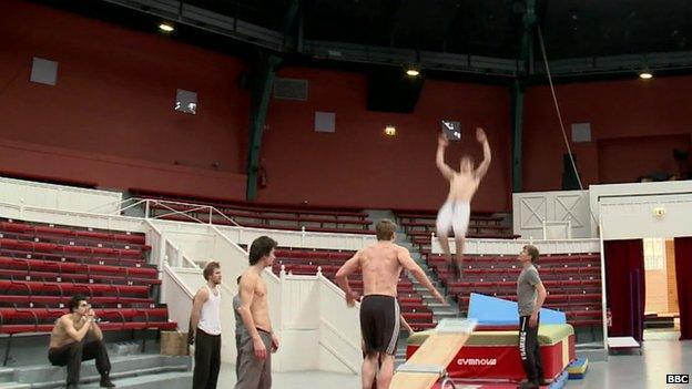 A team of circus acrobats practicing their jumps