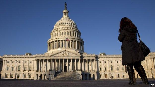 A woman looks at the US Capitol in Washington 31 December 2013