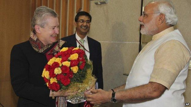 US Ambassador to India, Nancy Powell, left, receives flowers presented to her by India’s opposition Bharatiya Janata Party’s prime ministerial candidate Narendra Modi