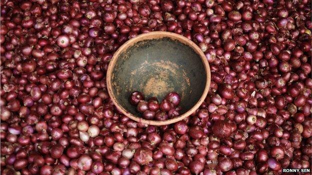 onions in a bowl on a mound of other onions