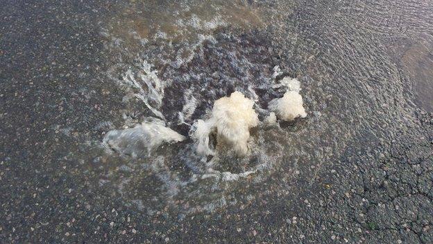 Water bubbling out of the drain covers on Hylton Road