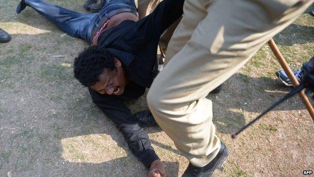 A demonstrator demanding a separate state of Telangana is detained by Indian policemen outside the parliament building in New Delhi on February 13, 2014