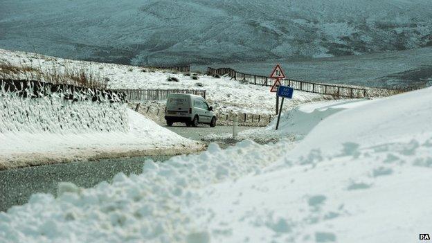 A car drives through snow on the Northumberland border