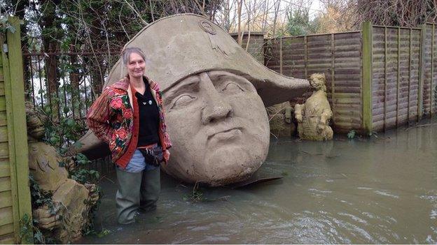 Sally Pemberton and a giant head of Napoleon in her garden