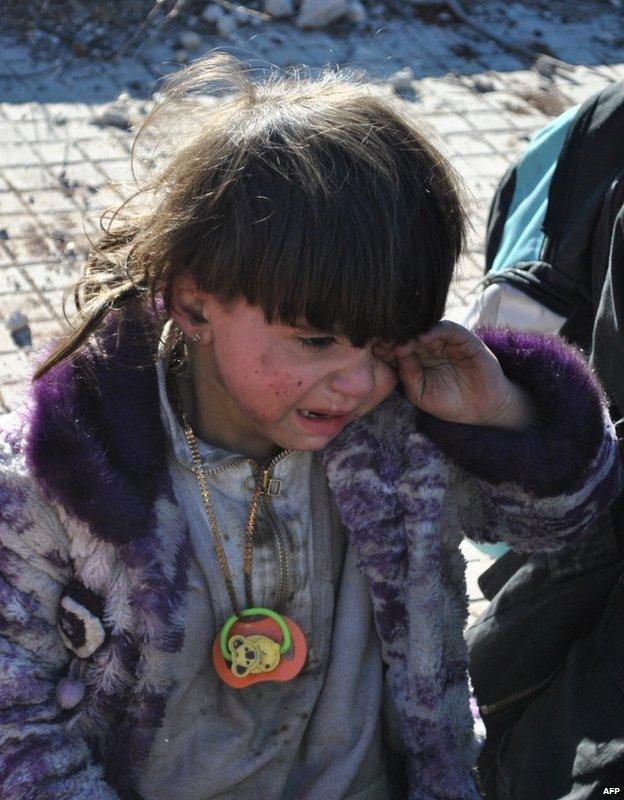 A child cries after being evacuated from the Old City of Homs, 12 February