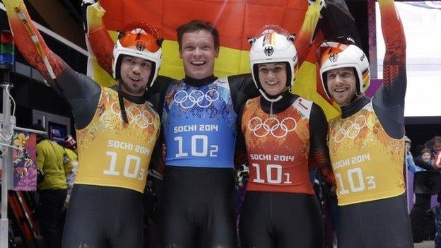 The German team of Felix Loch, in blue, Natalie Geisenberger, in orange, and doubles team of Tobias Wendl and Tobias Arlt, in yellow