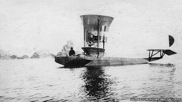 French seaplane moored off Sark coastline with man sitting on side of cockpit