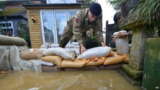 Soldiers placing sandbags around houses on Bridge Street, Chertsey