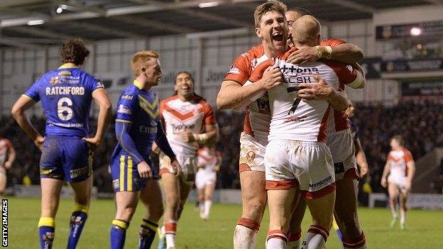 Luke Walsh of St Helens is congratulated on his try by team-mate Tommy Makinson