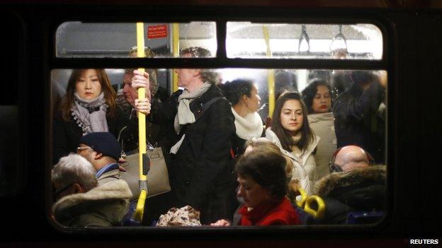 Commuters on a busy bus