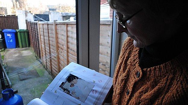 Karen looking at her precious photograph of her and George