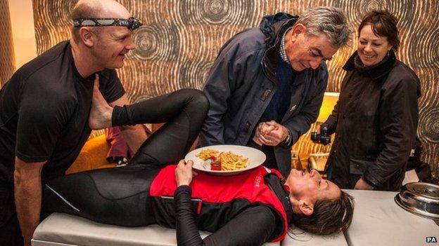 Davina McCall, with a plate of chips, and some physiotherapists