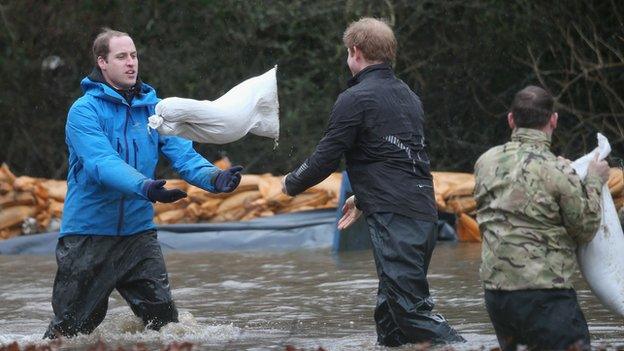 The Princes help move sandbags