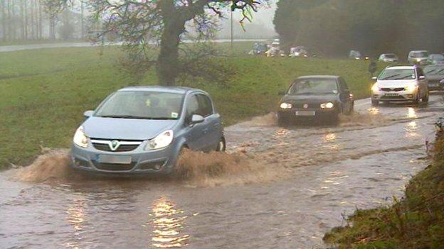 Cars on flooded road in Clyst St George