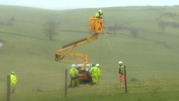 Engineers from ScottishPower working on lines in north Wales