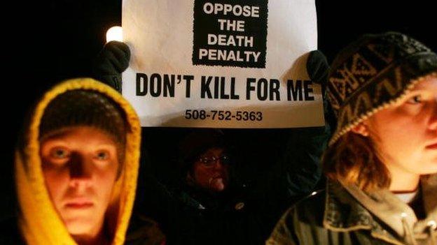 Anti-death penalty protestors hold signs in Enfield, Connectictut on Mary 13, 2005.