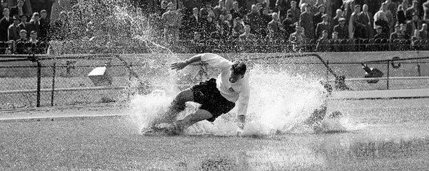 Finney splashes through a puddle during a Division One match at Stamford Bridge on 25 August, 1956