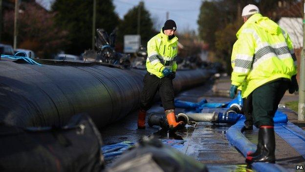 Aqua dam being installed to hold back flood water in Chertsey, Surrey