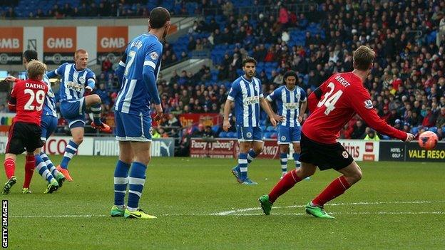 Wigan midfielder Ben Watson (second left) powers in a goal against Cardiff in their FA Cup tie