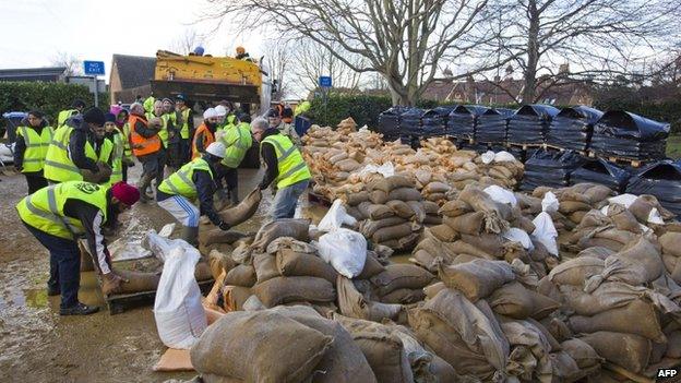 Volunteer moving sandbags