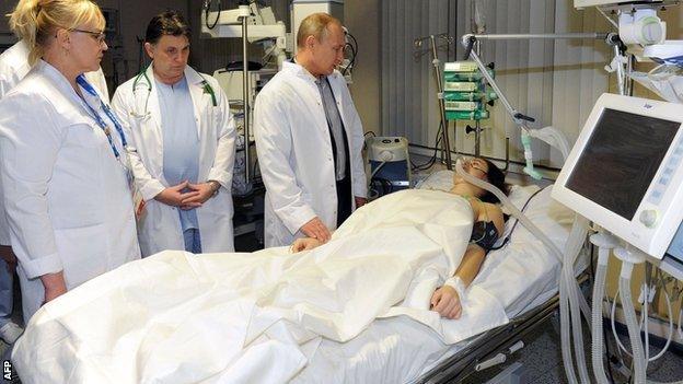 Vladimir Putin visits Russian freestyle skier Maria Komissarova in a hospital in Sochi