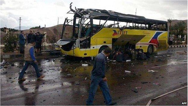 The wreckage of a tourist bus at the site of an explosion in the Egyptian town of Taba